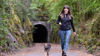 Woman walking dog on rural path