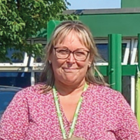 Sharon Edwards smiling outside school