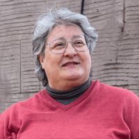 Woman with grey hair in glasses.