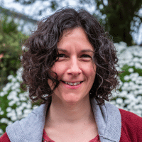 Portrait of woman smiling against floral backdrop