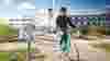 A woman wearing a helmet cycles over Sam Thompson Bridge in Belfast.