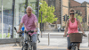 Steve and Debra cycling together in Stockton town centre