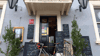 Front doorway of pub with blackboards and road bike leaning against the door