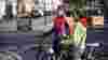 two women sitting on their bikes having a conversation in the street in a Low Traffic Neighbourhood in London